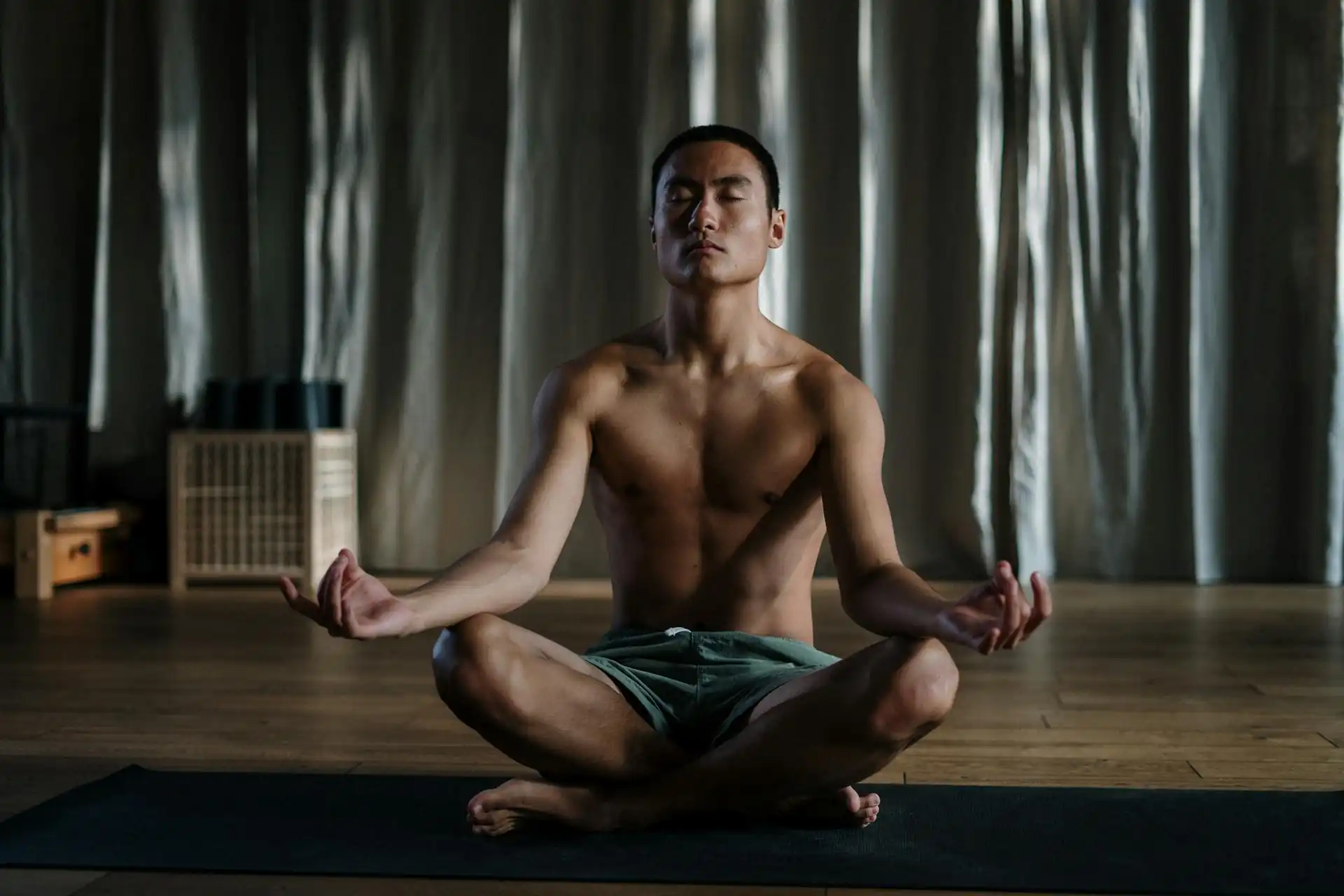 Daily Habits for Men: Young man meditating to boost focus, energy, and mental resilience through healthy routines