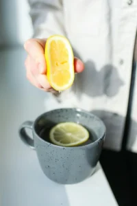 Men’s natural energy habit showing a man preparing lemon water as a stimulant-free morning routine for balanced daily energy