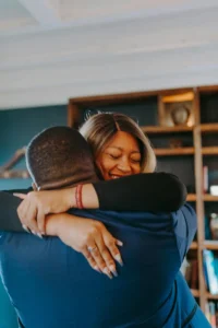 Warm hug for husband: a loving woman embracing her partner to help him feel more energetic and balanced